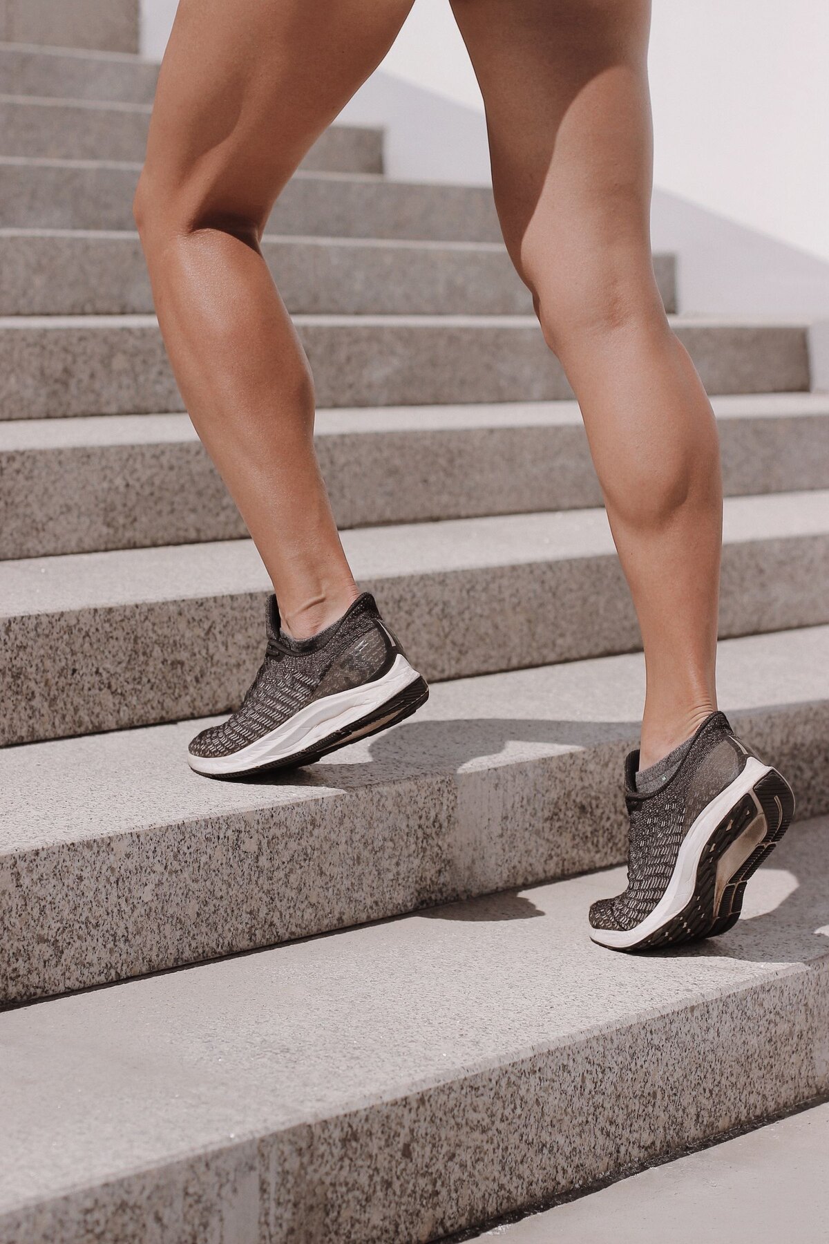 Sneakers stepping up outdoor stairs, illustrating a quick movement break